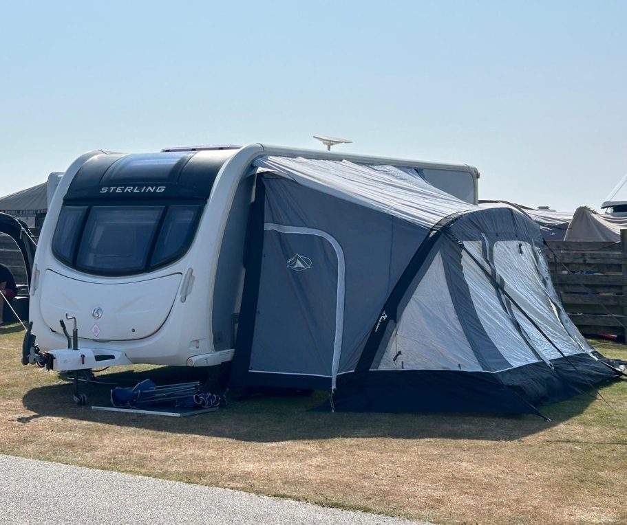 Touring Caravan Rental Setup SquaredAway touring caravan professionally set up with a full awning for a customer stay.